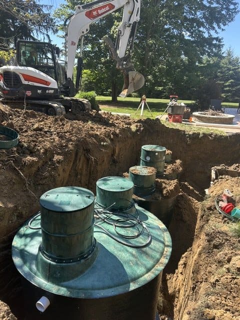 Aerobic septic system tank and risers in an excavated trench in Northeast Ohio Aerobic septic system tank and risers in an excavated trench in Northeast Ohio