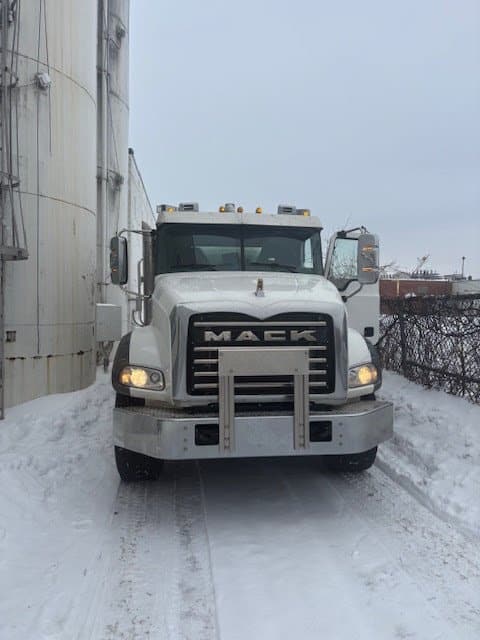 Commercial septic services: Double Flush Septic pumping truck at a commercial site in winter