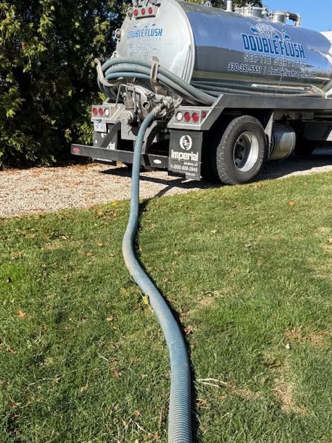 Double Flush Septic truck with hose run to a septic tank lid for inspection and pumping Double Flush Septic truck with hose run to a septic tank lid for inspection and pumping